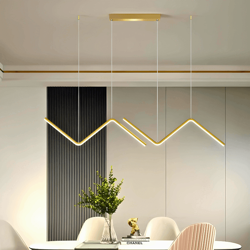 Pendente dourado aceso sobre mesa de jantar com planta e parede de ripas pretas