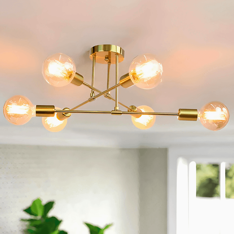 Lustre sputnik dourado de hastes cruzadas com seis lâmpadas de filamento âmbar acesas
