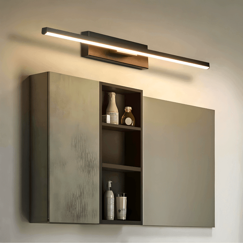 Arandela preta de LED na horizontal acima de um armário com espelho, acesa