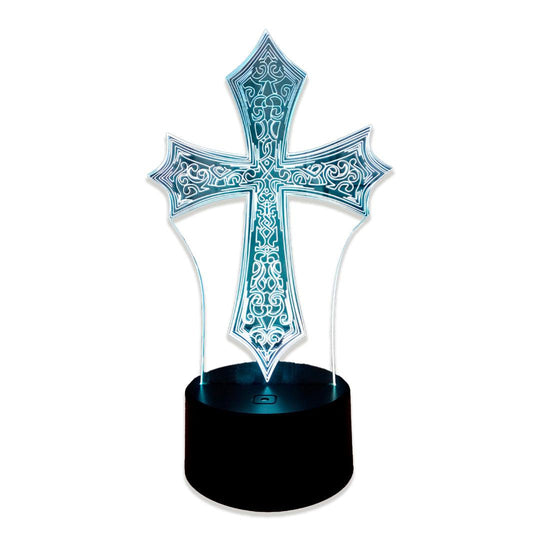 Cruz ornamentada de acrílico com arabescos gravados, acesa em azul claro sobre fundo branco