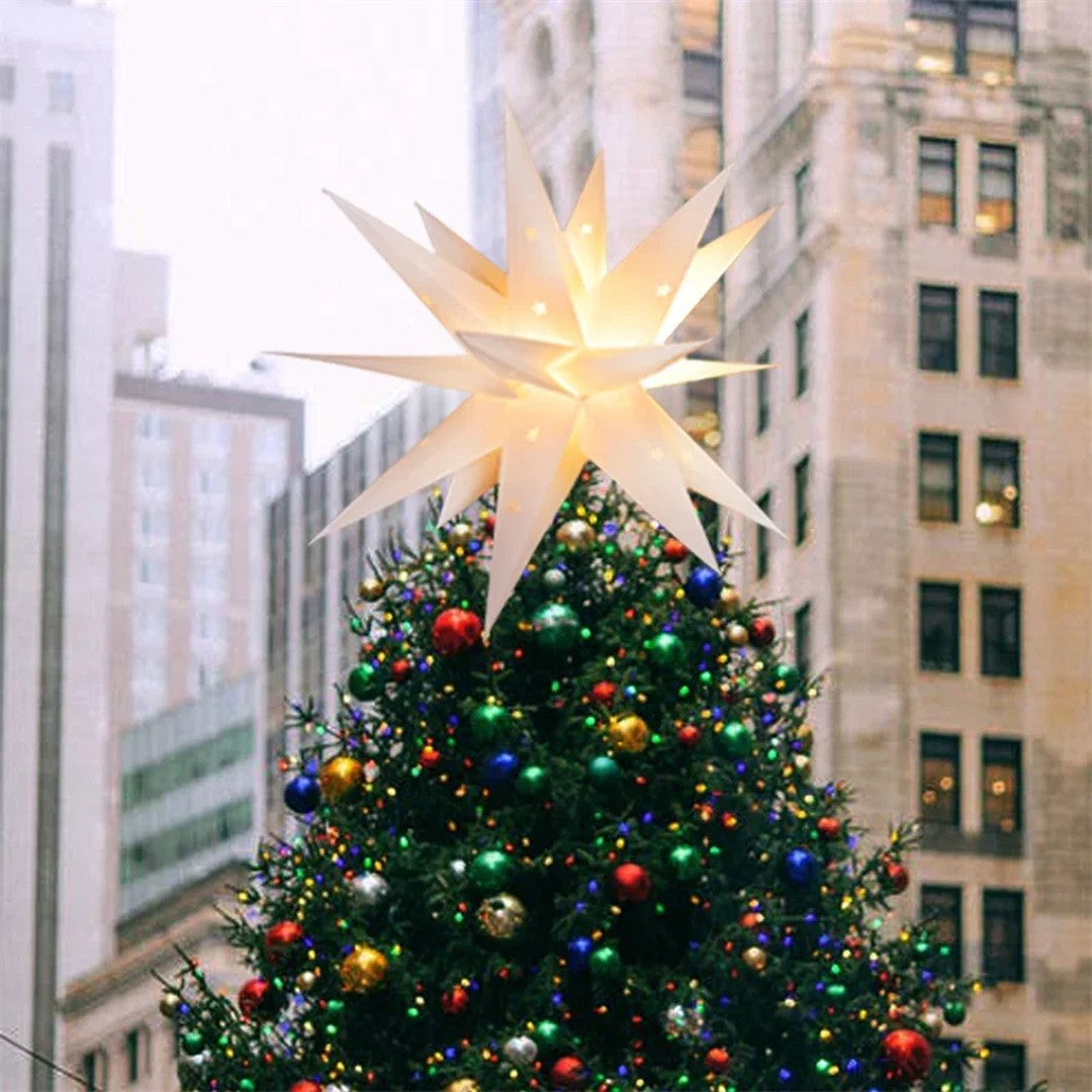 Ambiente · estrela no topo de uma árvore de Natal na cidade